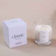 Amaraa classic pine soy wax candle with minimalist white packaging on beige background